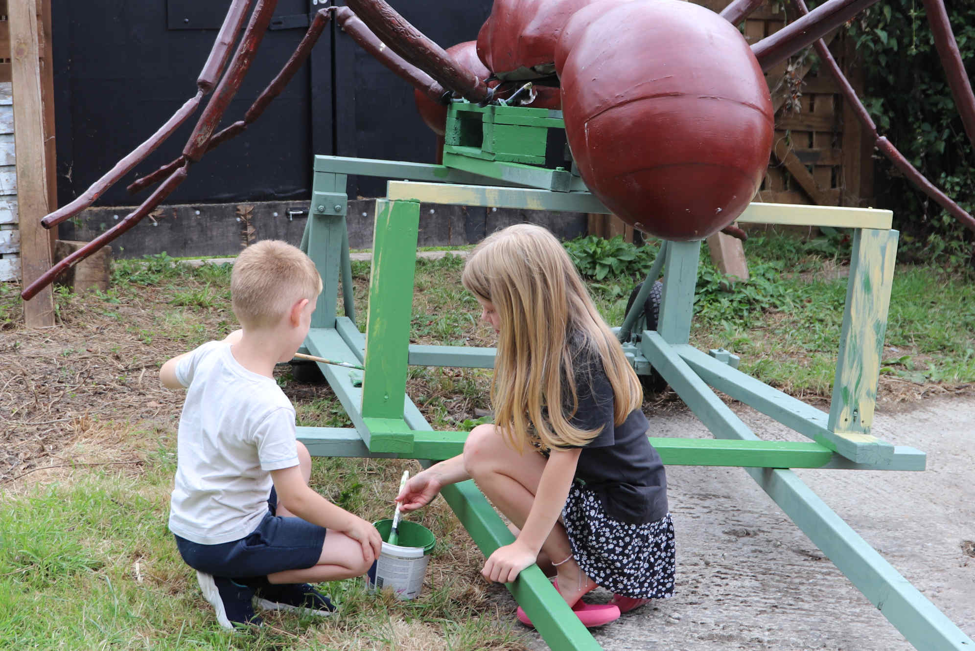 MASTER & MISS OCEAN - Young conservationists painting the wooden cart green. Copyright photograph  August 2024, all right reserved, Herstmonceux Museum Limited. You will need permission from the author or Lime Park Heritage Trust in order to use this picture.